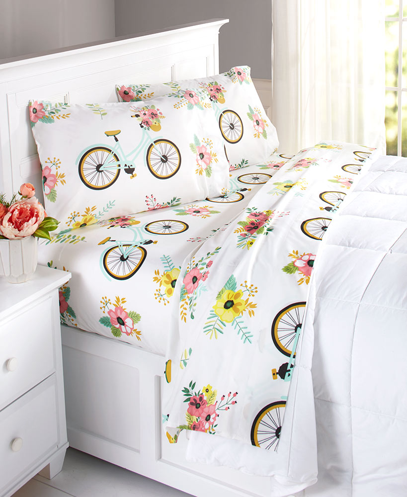 white sheets with bicycle pattern on bed