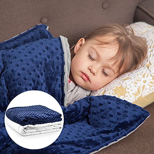 young child sleeping under blue weighted blanket