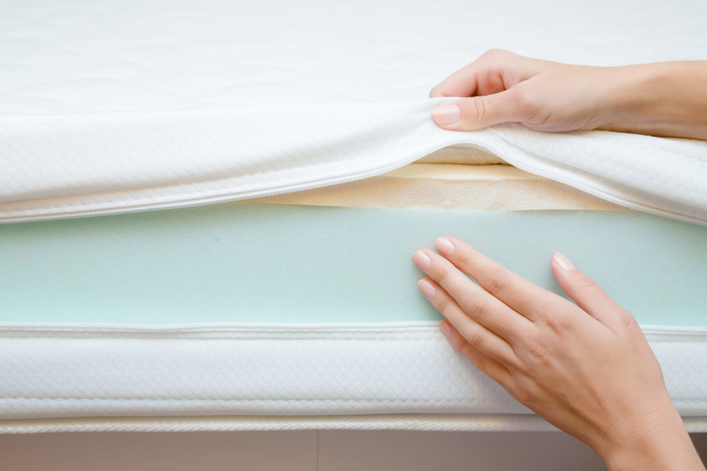 Woman’s Hands Touching Different Layers of New Mattress
